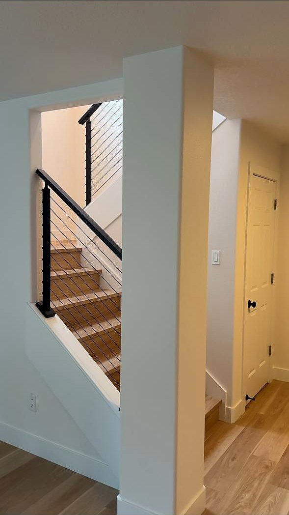 Cable railing stair seen past a painted column
