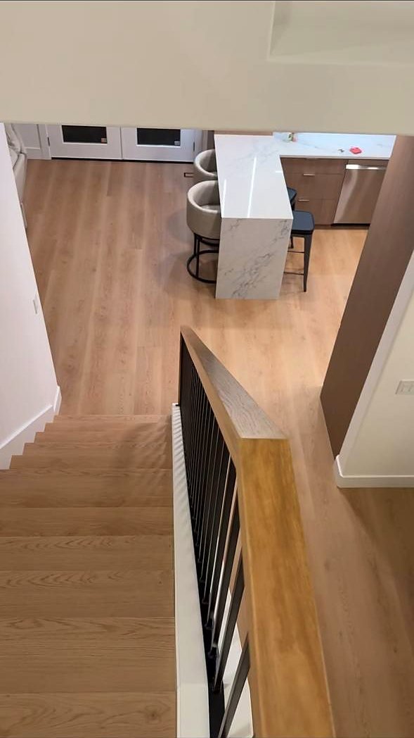 Stair overlook with oak handrail and iron balusters