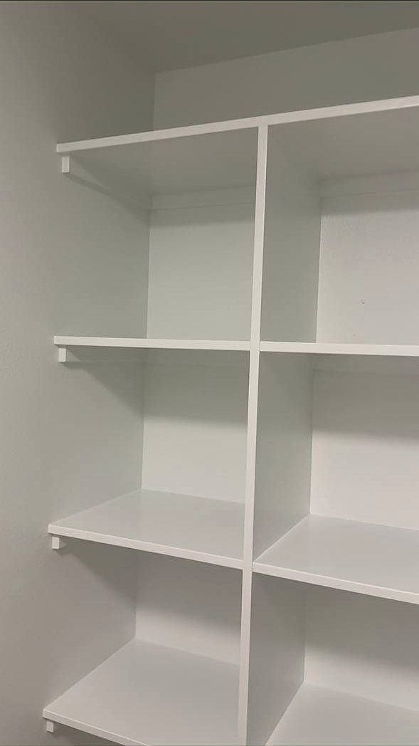 White painted pantry and linen shelving