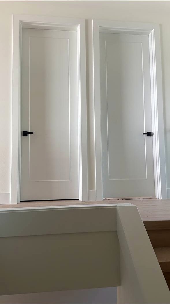 Pair of white shaker doors with black lever handles